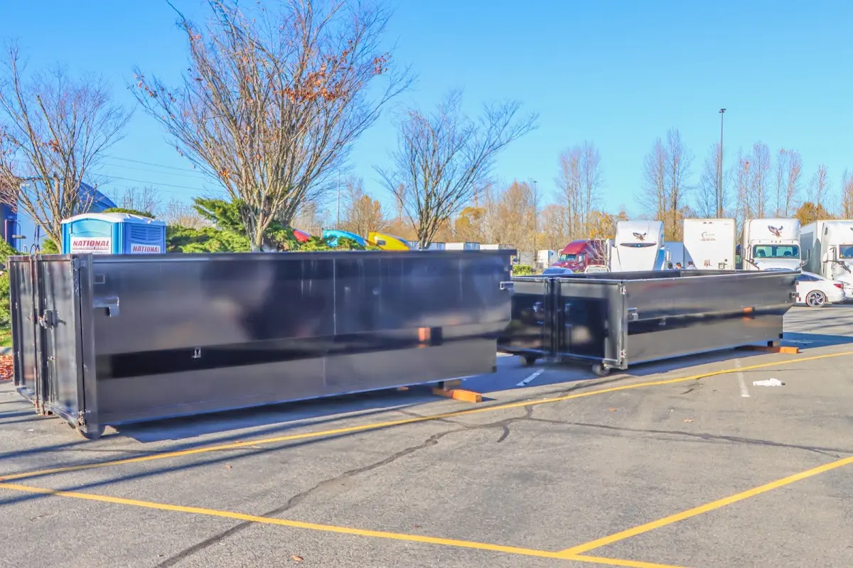 Professional dumpster rental service with roll-off container on residential driveway in Louisburg